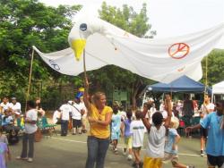 Montessori peace dove held aloft by teacher Courtney Jenkins and others as students file out after the program.